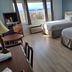 Carolyn Beach Inn, Thessalon: guest room with two beds and lake view through large windows