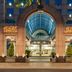 Marquis Reforma Mexico City hotel entrance at night with arched glass canopy and lit facade