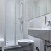 Dom Hotel Augsburg bathroom with glass shower, wall-hung toilet, sink and towel radiator