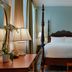 Voco St. James Hotel by IHG, New Orleans: four-poster bed in a classic guest room with lamps and window light