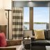 Hilton Motif Seattle guest room with sofa and large windows overlooking Seattle waterfront