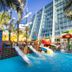 Crown Paradise Club Cancun in Cancún with colorful kids water park, slides and poolside palm trees