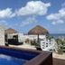 Flamingo Hotel Cozumel poolside ocean view with thatched palapas and lounge beds