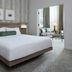 Delta Hotels by Marriott London Armouries bedroom with king bed and sitting area