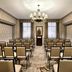 Omni Parker House Boston meeting room with rows of chairs, chandelier, and podium