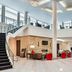 Four Points by Sheraton London lobby with curved staircase, lounge seating, and bright atrium