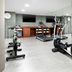 AC Hotels by Marriott La Rioja fitness room with treadmills, ellipticals, dumbbells and wall mirrors in Logroño