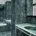 AC Hotels by Marriott La Rioja bathroom with green marble walls, glass shower and vessel sink in Logroño