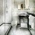Staypineapple, An Elegant Hotel, Union Square bathroom with marble walls, glass shower, and vanity