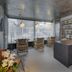 Tropica Beach Hotel San Juan lounge with wicker chairs, bar counter and patterned wallpaper
