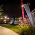 Night view of Thunderbird Boutique Hotel in Las Vegas with lit walkway, fountain, and palm trees