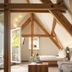 Dom Hotel Augsburg attic suite with exposed beams, sofa, bed and balcony door