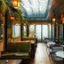 The Hotel Chelsea in New York lounge with skylight, lanterns, and small tables
