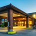 Comfort Inn Kingston - Highway 401 exterior entrance with covered driveway and evening lighting in Kingston