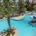 Alexis Park All Suite Resort in Las Vegas, aerial view of a tropical-style outdoor pool with palm trees
