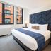 Hotel Indigo Boston Garden By IHG room with king bed, geometric headboard, and Boston window view