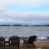 Carolyn Beach Inn in Thessalon: Adirondack chairs on a sandy beach facing the lake and island view