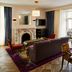 The Hotel Chelsea, New York: elegant suite with fireplace, sofa, and Parisian-style balcony doors
