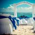 Grand Oasis Tulum in Akumal beach wedding setup with white chairs, arch and ocean view