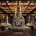 Grand Bohemian Lodge Greenville lobby with stone fireplace, wood ceiling, and lounge seating