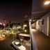 Thunderbird Boutique Hotel in Las Vegas with rooftop view of illuminated pool, city skyline and tower