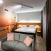 Original Sokos Hotel Lappee room with sofa, double bed and sunset wall mural in Lappeenranta