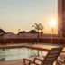 Sunset view of poolside loungers and umbrellas at Luxor Soft Hotel Teresina, Teresina