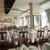 Britannia International Hotel London restaurant with set dining tables and arched windows