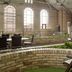 Delta Hotels by Marriott London Armouries indoor atrium with brick arches and garden seating in London