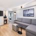 Radisson Hotel Seattle Airport guest room with sofa, desk, TV and kitchenette in SeaTac