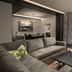 Grand Bohemian Lodge Greenville, Autograph Collection suite with gray sofa, armchair, coffee table, and large window