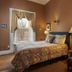 The College Club of Boston guest room with bed, armchair, and window view in Boston