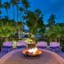 The Royal Sonesta San Juan in Carolina features a fire pit terrace with purple chairs and tropical palms