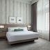 Delta Hotels by Marriott London Armouries guest room with king bed and tall window in London
