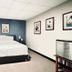 Sj Suites Hotel San Juan guest room with bed, blue accent wall and framed art