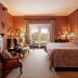 The College Club of Boston in Boston guest room with fireplace, seating area and city-view window