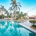 Fiesta Americana Cozumel pool area with palm trees, loungers, and clear turquoise water