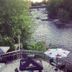 Petawawa River Inn & Suites in Petawawa overlooking a river from a patio with tables and umbrellas