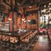 The LINQ Hotel & Casino Las Vegas bar with high stools, red pendant lights and wood-paneled interior