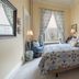 The College Club of Boston Boston guest room with patterned bed, bay window, chair, and dresser