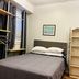 Saint Lawrence Residences and Suites Toronto bedroom with bed, shelves, wardrobe, and framed wall art