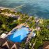 Allegro Cozumel beachfront resort with pool, palm trees and oceanfront pier in Cozumel