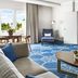 Fairmont El San Juan Hotel in Carolina suite with blue patterned rug and ocean-view balcony