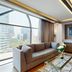 Marquis Reforma Mexico City suite with city view, sofa seating, and wall-mounted TV