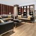AC Hotels by Marriott La Rioja lounge in Logroño with black sofas, coffee table and bookshelves