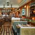 The Hotel Chelsea in New York bar interior with checkered floor, long counter, and booth seating