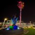 Thunderbird Boutique Hotel in Las Vegas courtyard at night with illuminated palm sculpture, fountain, and walkway
