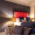 62 Castle Street Liverpool guest room with patterned wall, red headboard, and tufted sofa