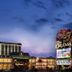 The Orleans Hotel & Casino in Las Vegas exterior at dusk with illuminated entrance and casino sign