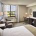 Waterfront Hotel Downtown Burlington room with bed, desk, TV and window view in Burlington